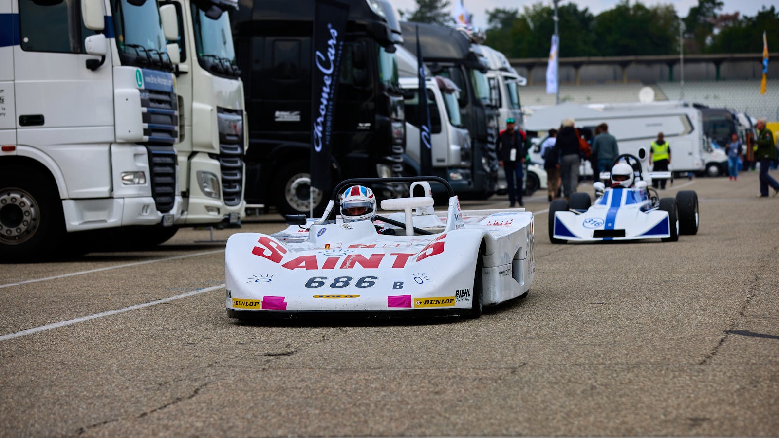 Vintage race cars competing at the Hockenheim track event, showcasing automotive history.